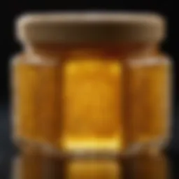 Close-up view of royal jelly in a glass container showcasing its texture and color.